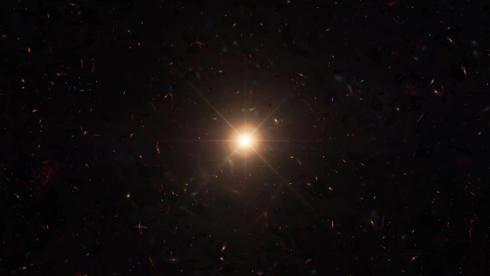 Faint red primordial galaxies at cosmic dawn with a brilliant point of light marking a nascent black hole seed